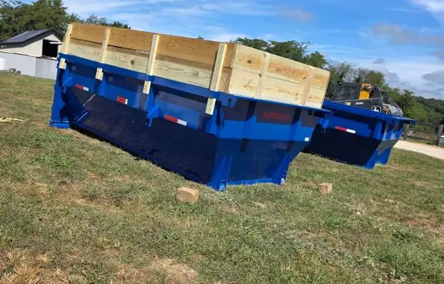 Blue 20-yard dumpsters staged and ready for delivery