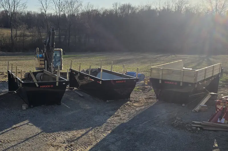 Hurst Earthworks dumpsters staged next to an excavator